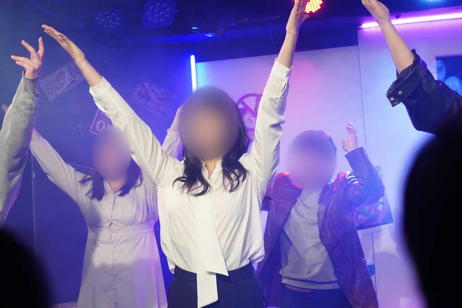 공연 마지막에 단원들이 두 팔을 높이 들고 환하게 웃는 장면입니다.